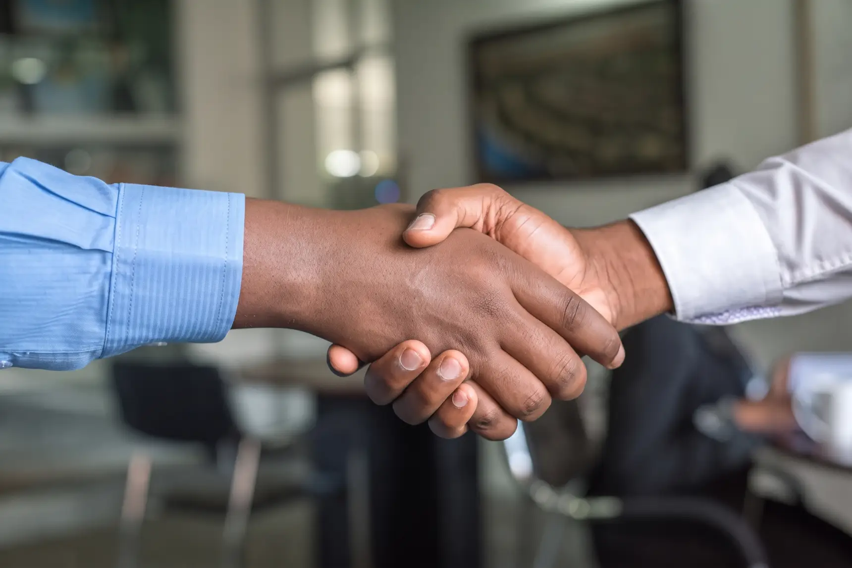 A handshake across an office table